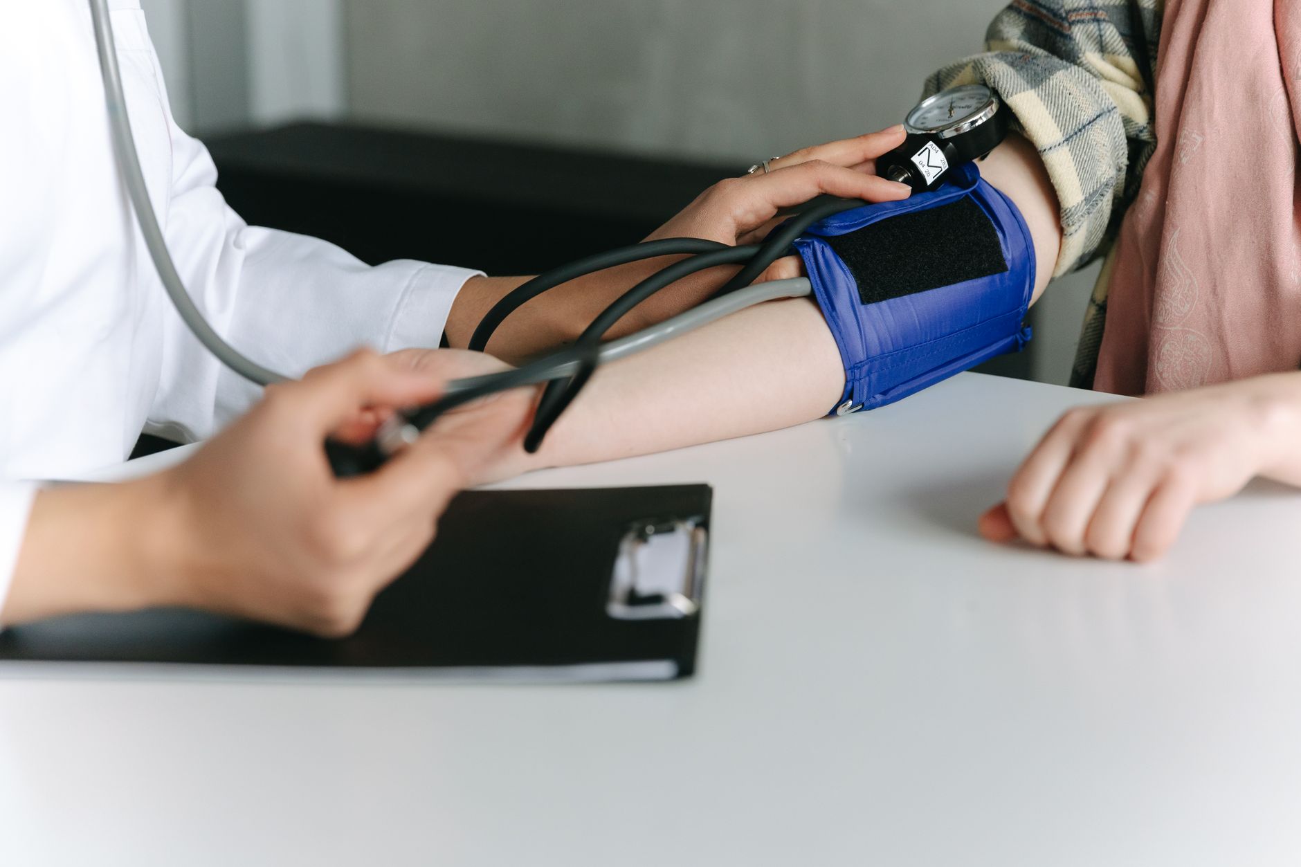 Close-up of a blood pressure cuff on an arm showing an accurate home blood pressure monitoring setup
