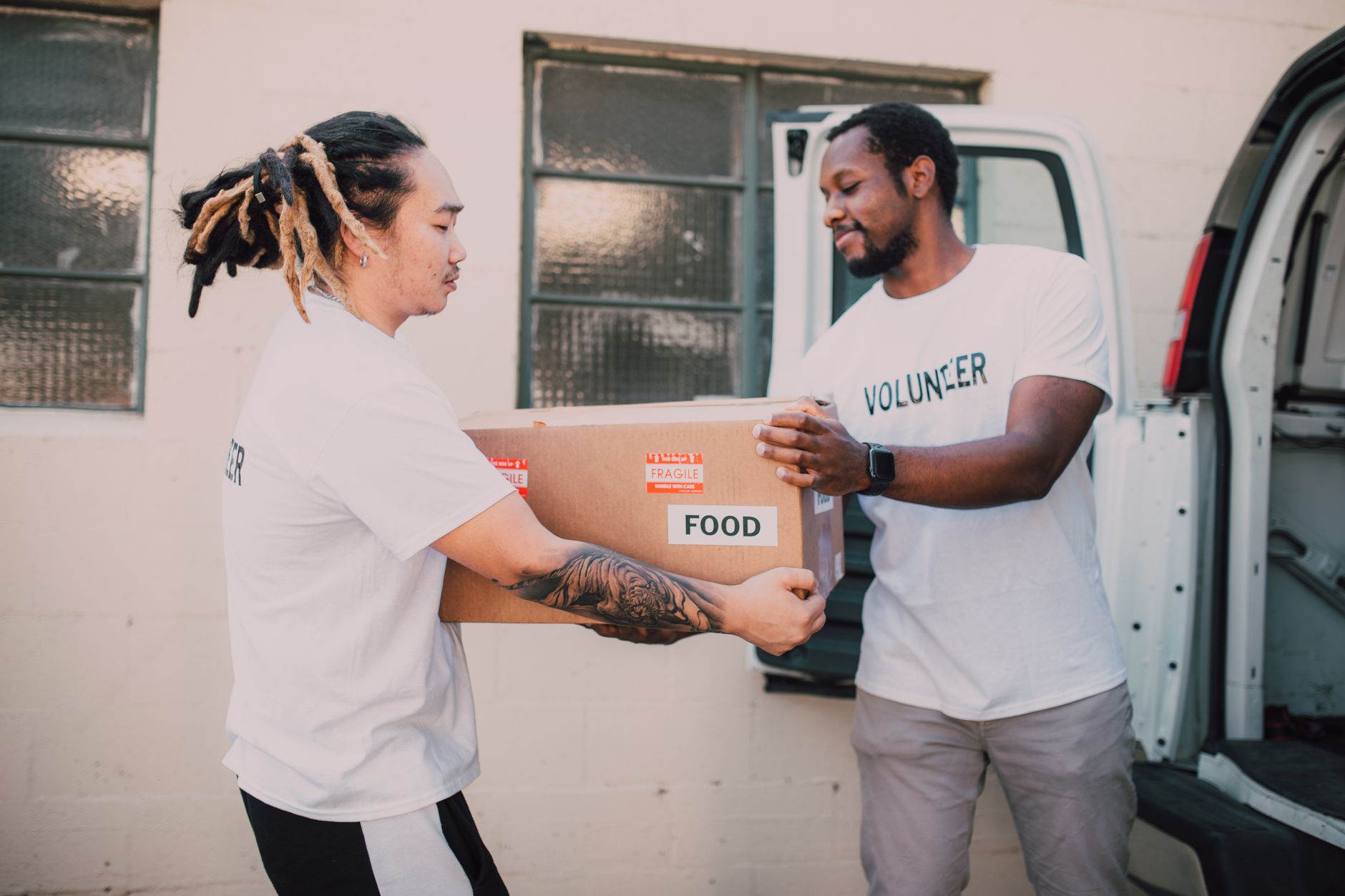 Volunteer packing food parcels during winter, an example of how volunteering mental health winter benefits extend to indoor roles too